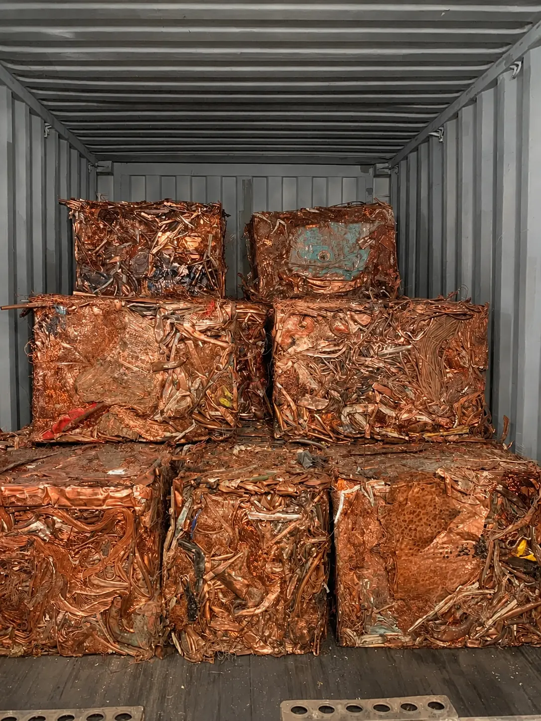 Compressed copper scrap bales loaded inside a shipping container